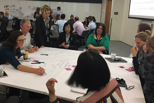 Photo of group of staff working around a table at MBIE