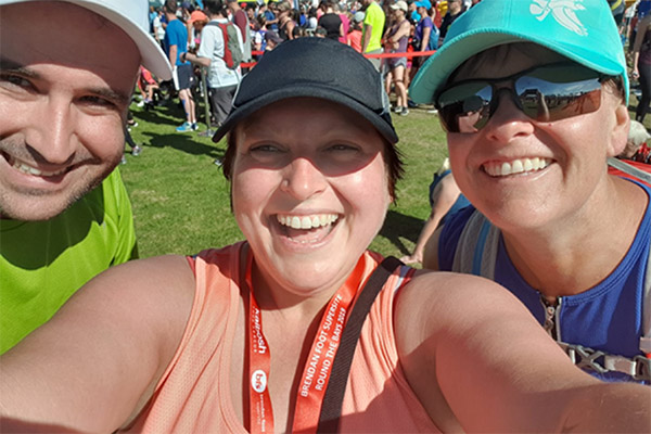 Selfie photo of three people at fun run event
