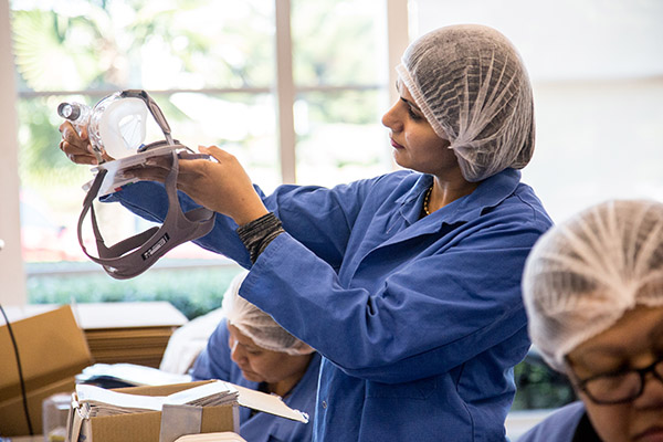 Photo of Fisher & Paykel Healthcare female employee looking at equipment