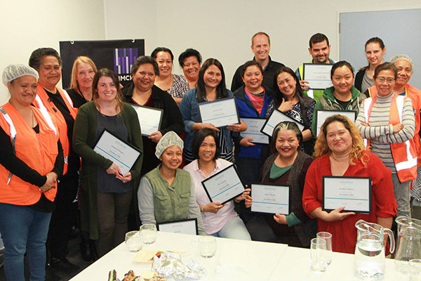 Photo of group of Simcro workers with certificates from the literacy and numeracy training programme