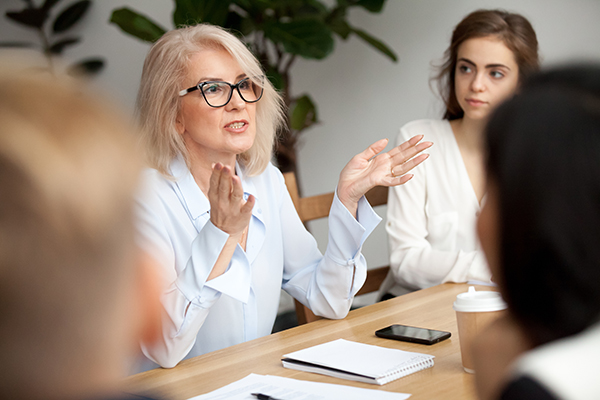 Business woman talking to group