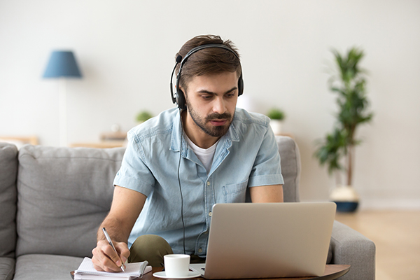 Man at home undertaking online learning