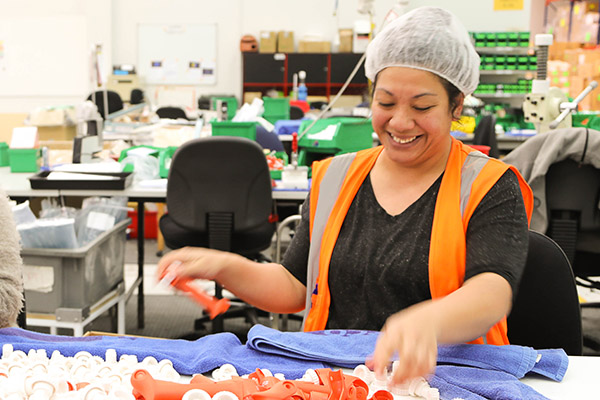 Woman working in Simcro factory in Hamilton making animal health products