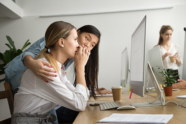 Woman comforts upset co-worker