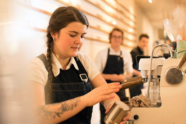 photo of female barista making coffee