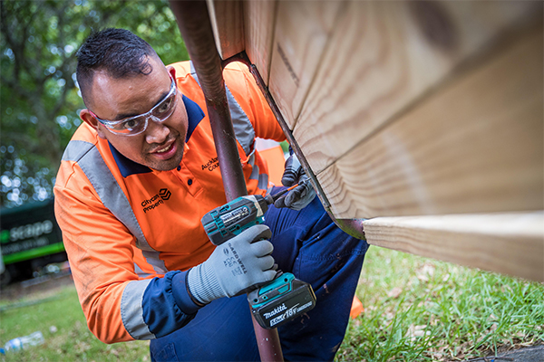 photo of citycare worker drilling wood