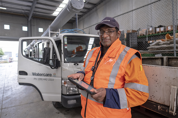 photo of Watercare worker in front of van