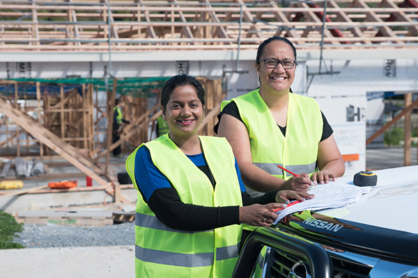 Two women working on a building site