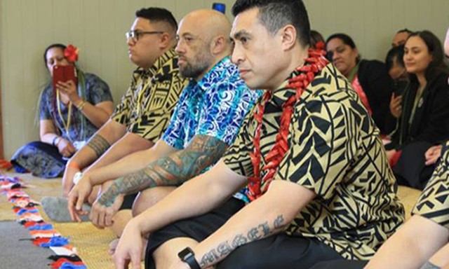 Pacific Island men sitting cross legged at work conference