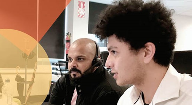 Photo of young man working alongside older man at computer taken from the cover of the 2021 New Zealand Workplace Diversity Survey report