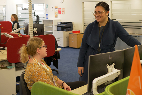 Two woman chatting at office desk