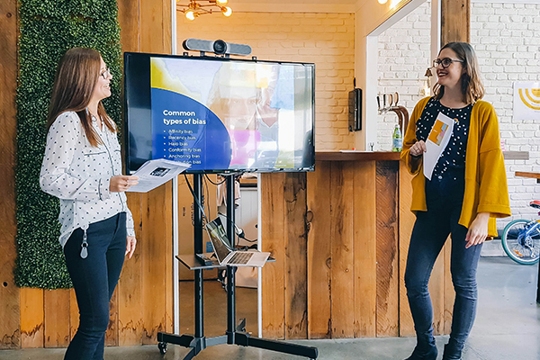 Two women presenting workshop on bias