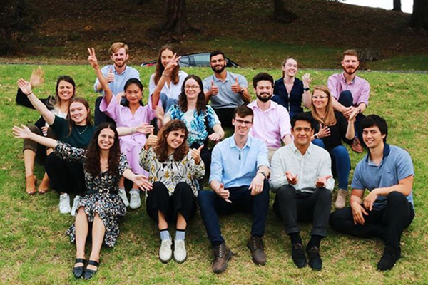 Group in corporate wear sitting on hill