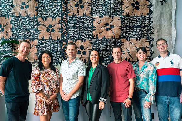 Group of people in front of Pacific weaving