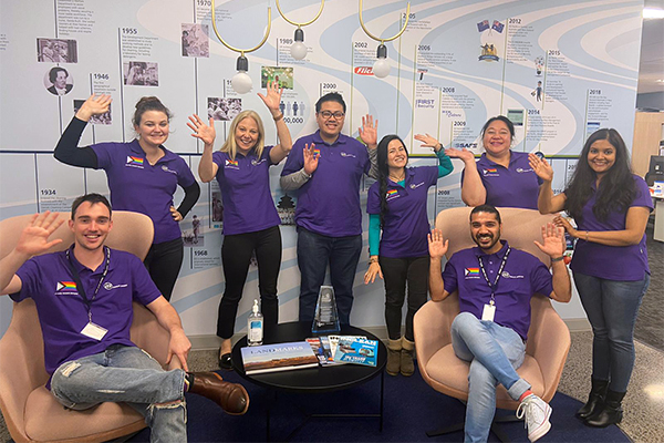 Group waving in purple tshirts