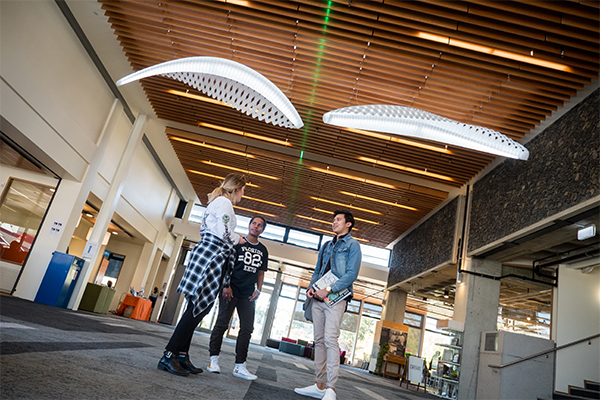 Students talking in campus corridor