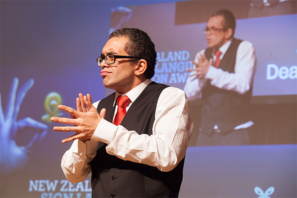 Man doing sign language on stage