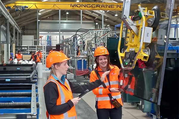 Female staff in safety gear working on site