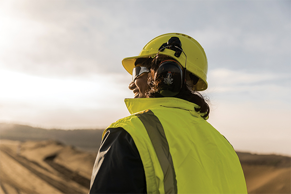 Female worker in safety gear on site