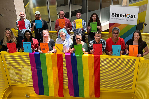 People holding colourful signs reading 'We are StandOut'