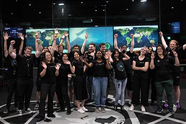 Rocket Lab interns in front of global maps