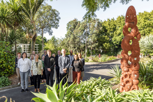 Signing of Tono strategy next to Māori sculpture