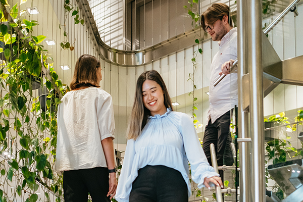 Colleagues walking down stairs, smiling