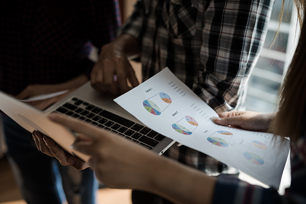 Photo of a group of people discussing data collection in the office.