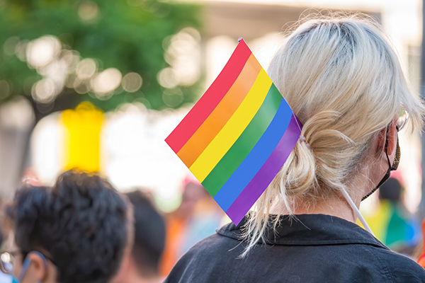 Woman with rainbow flag in hair