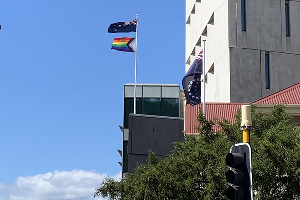 Pride flag flying on building