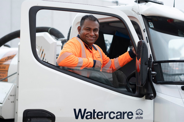 Man climbing into cab of Watercare vehicle